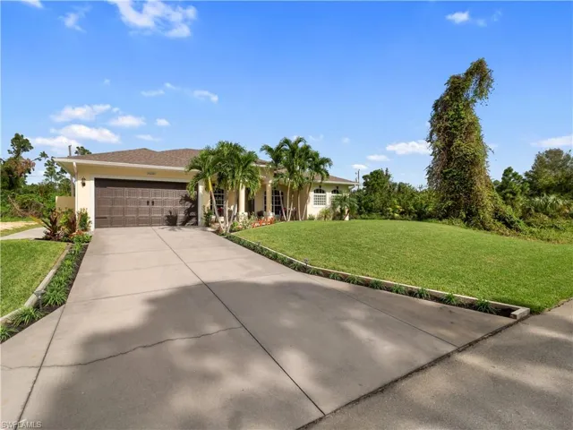 View of front of house featuring a front yard and a garage