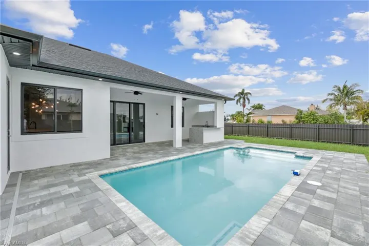 View of swimming pool featuring ceiling fan and a patio