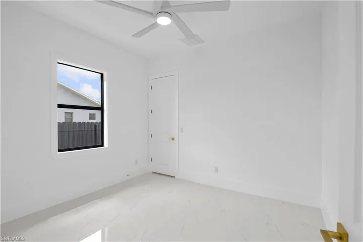 Spare room with ceiling fan