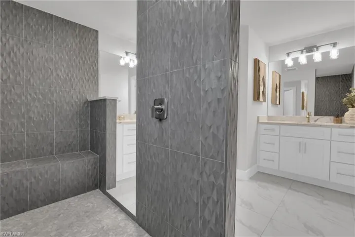 Walk-in shower with textured wall tiles and built-in bench