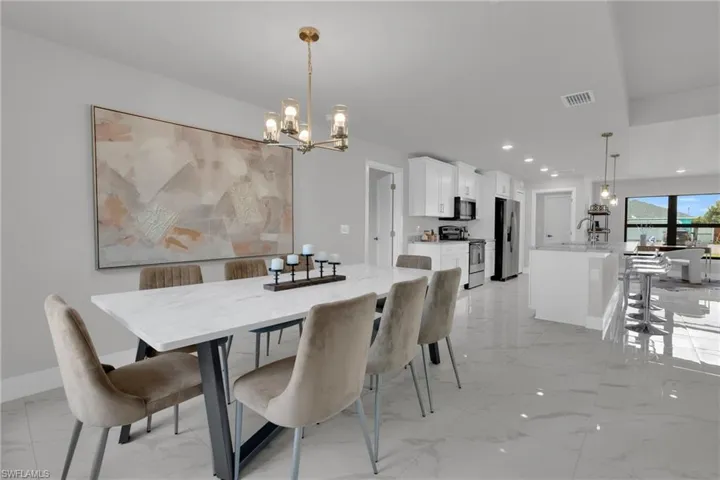 Open-concept interior featuring a dining area, kitchen, and living space