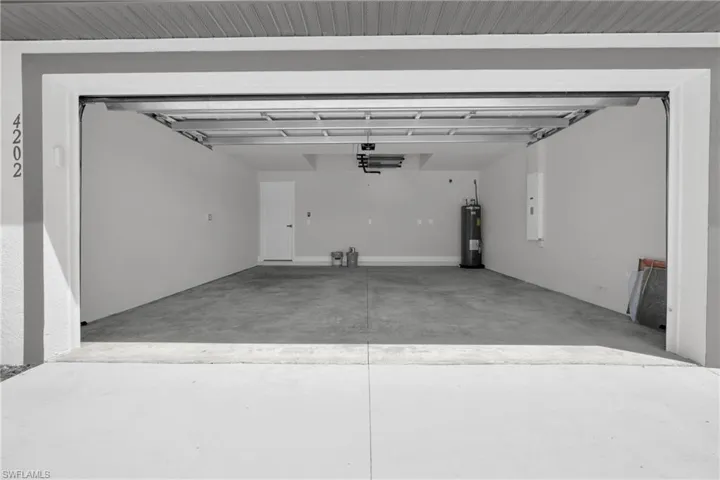 Spacious garage with concrete flooring and painted walls