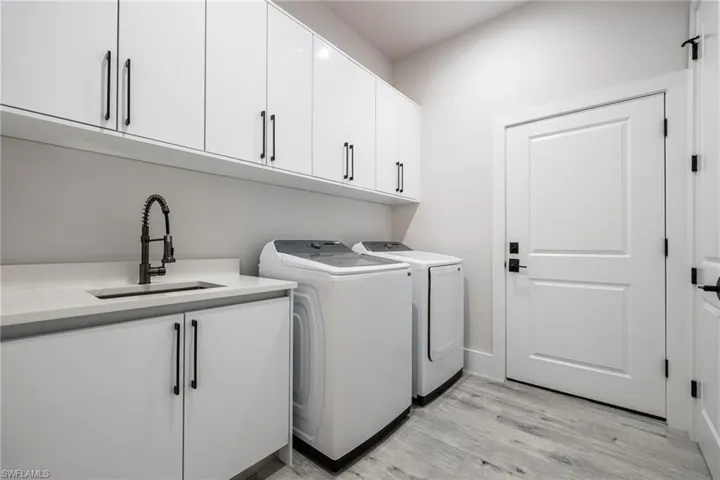 Laundry Room with cabinetry, Laundry Tub, and Storage!