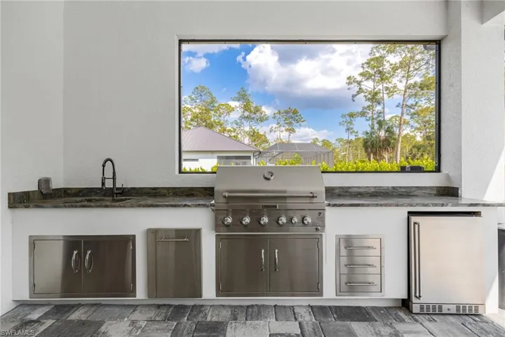 Built-in Summer Kitchen with Wet Bar, Mini Refrigerator, and Gas Grill!