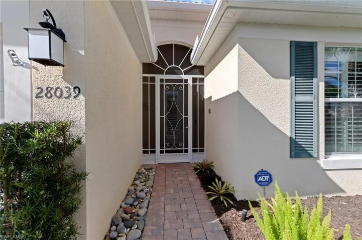 Doorway to property with stucco siding