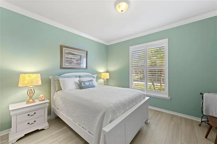 Bedroom featuring ornamental molding and light wood-style floors