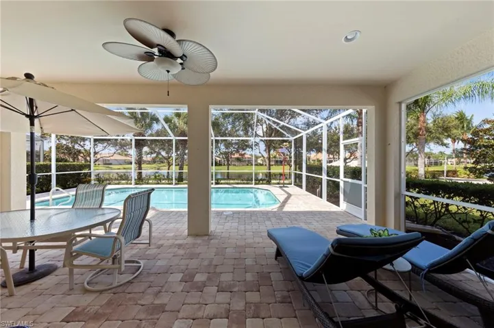 Outdoor pool featuring a patio area, a sunroom, a lanai, and ceiling fan