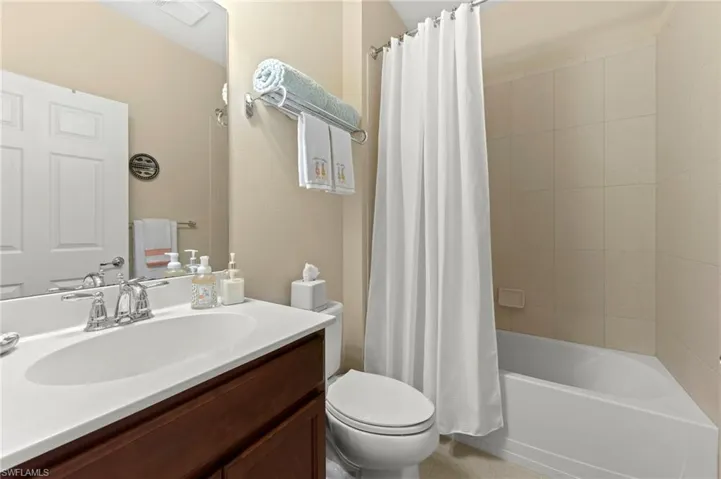 Full bathroom featuring shower / tub combo and vanity