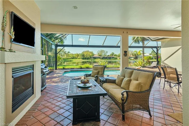 View of patio featuring an outdoor living space with a fireplace, a lanai, and an outdoor pool