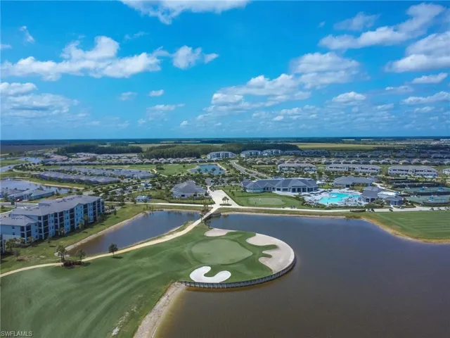 Aerial perspective of suburban area with a large body of water and a golf club