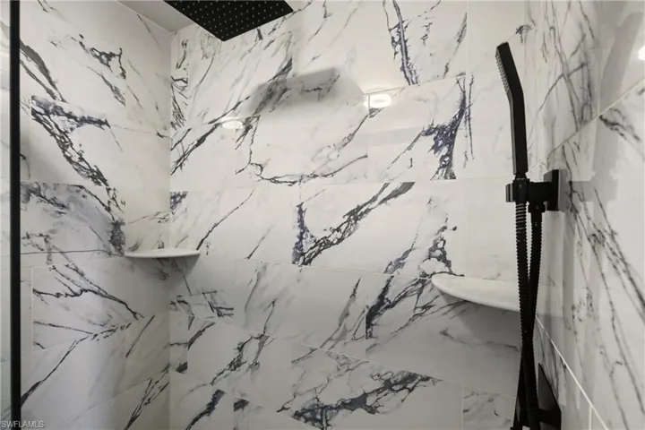 Bathroom featuring a marble finish shower