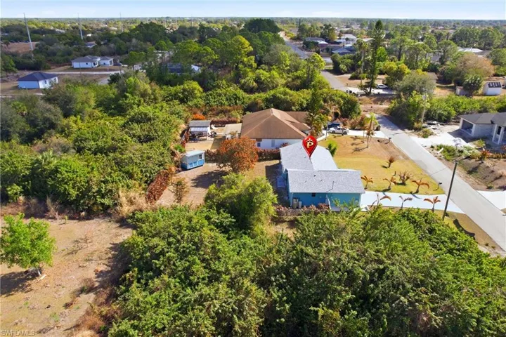 Aerial view of residential area featuring a tree filled landscape