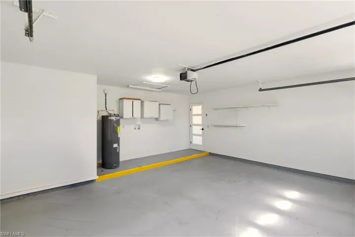 Garage with electric water heater and a garage door opener