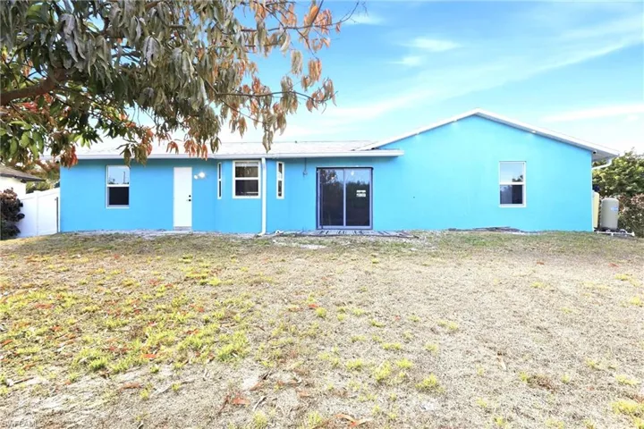 Rear view of house with stucco siding
