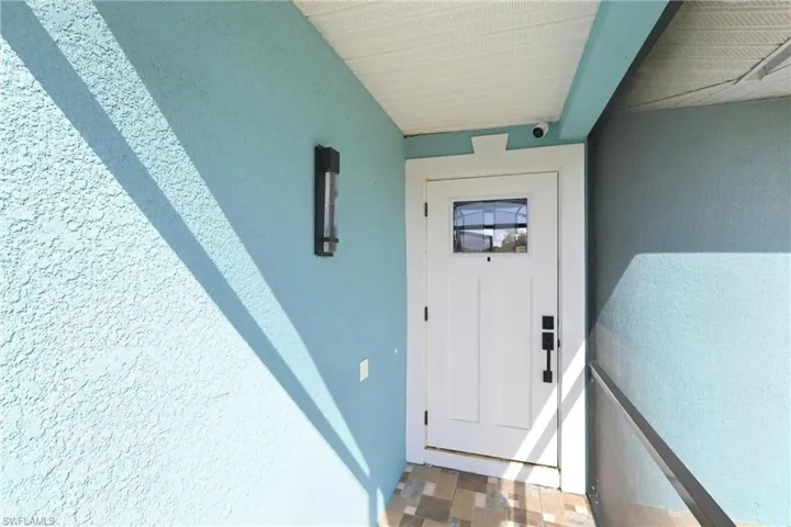 Doorway to property with stucco siding