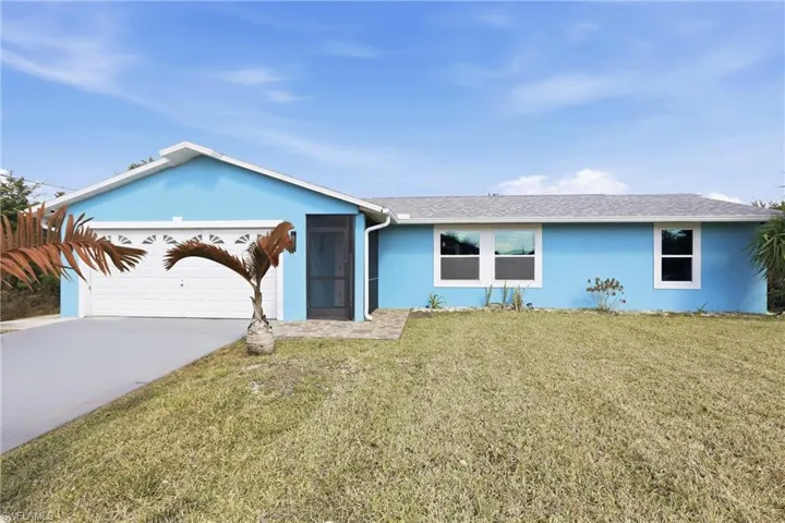 Single story home with stucco siding, a front yard, concrete driveway, roof with shingles, and an attached garage