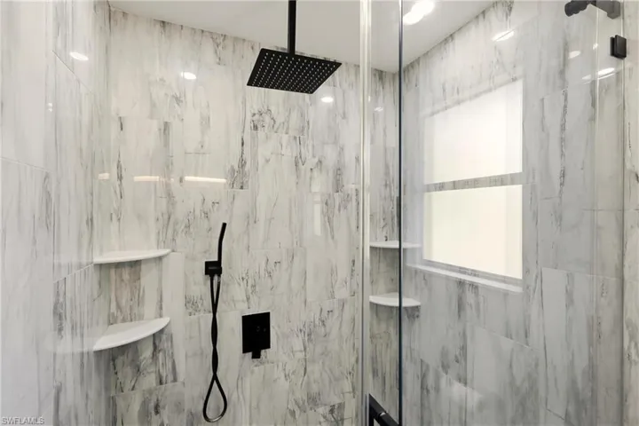 Bathroom with a marble finish shower