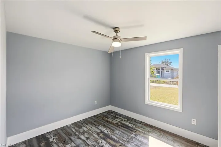 Spare room featuring wood finished floors and a ceiling fan