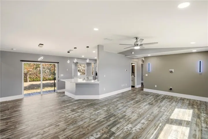 Unfurnished living room featuring light wood-style floors, recessed lighting, and a ceiling fan