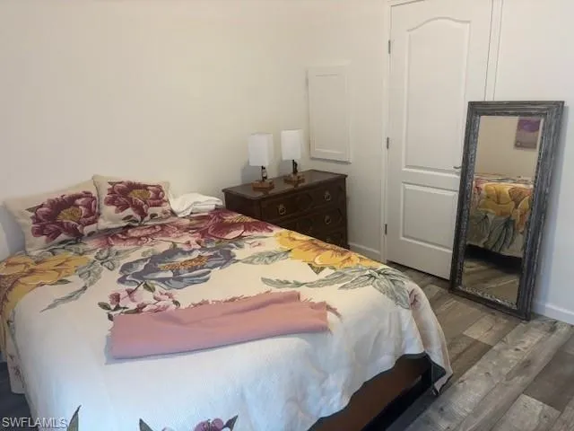 Bedroom with dark wood-style floors
