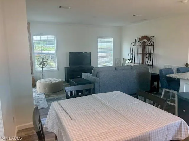 Bedroom featuring multiple windows and ornamental molding