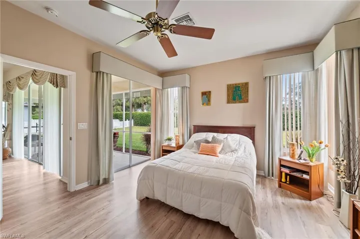 Bedroom featuring ceiling fan, access to outside, and light wood-type flooring