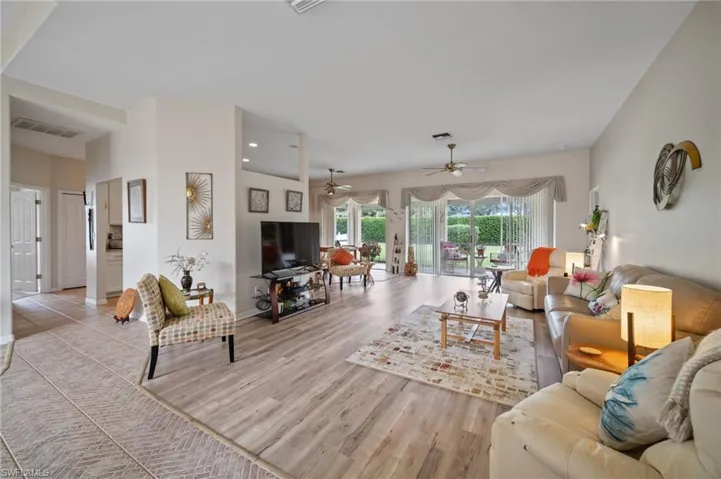 Living room with light wood-type flooring and ceiling fan