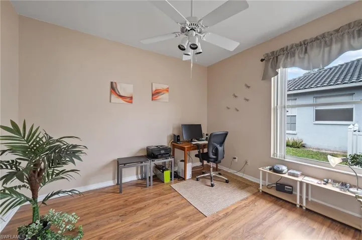 Home office featuring ceiling fan and light wood-type flooring
