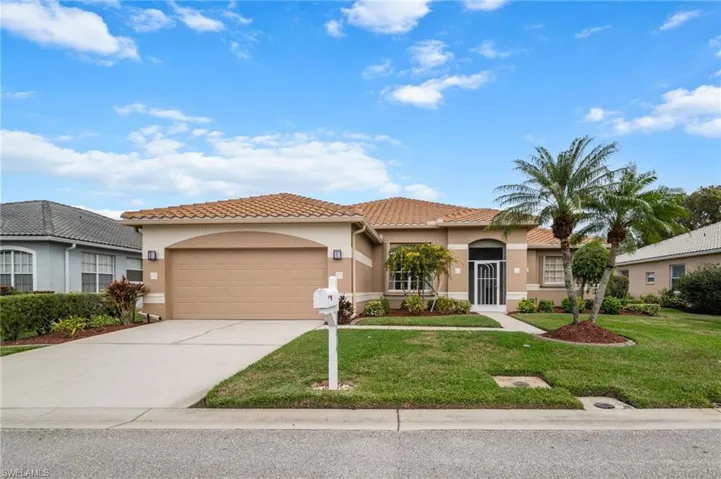Mediterranean /Spanish house featuring a garage and a front lawn