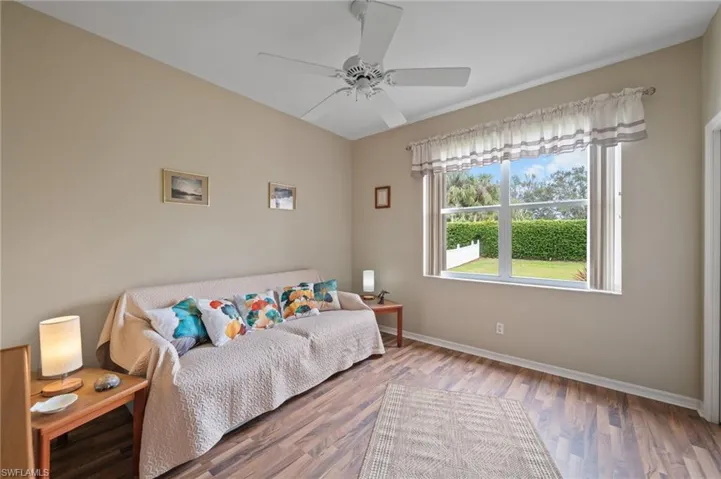 Bedroom with ceiling fan and hardwood/wood-style floors