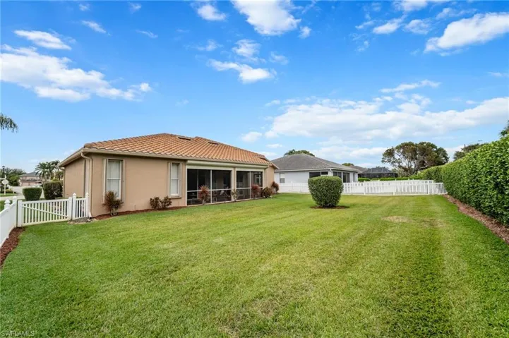 Back of property with a yard and a sunroom