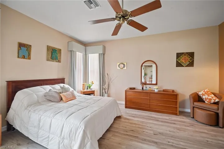 Bedroom with ceiling fan and light wood-type flooring