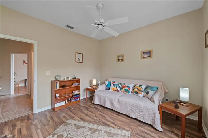 Bedroom featuring ceiling fan and hardwood / wood-style flooring