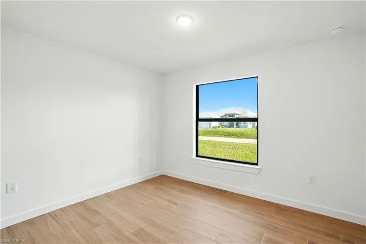 Empty room with baseboards and light wood-style floors