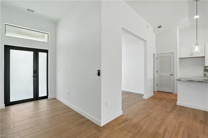 Entryway featuring lofted ceiling and light wood-style flooring