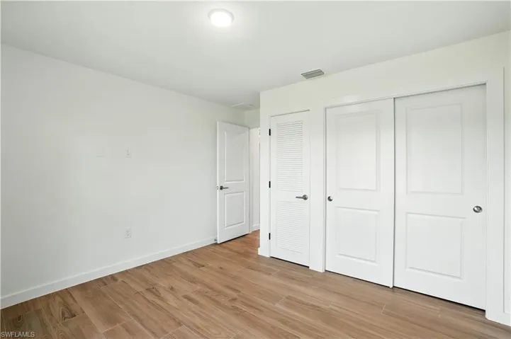 Unfurnished bedroom with light wood-style flooring and a closet