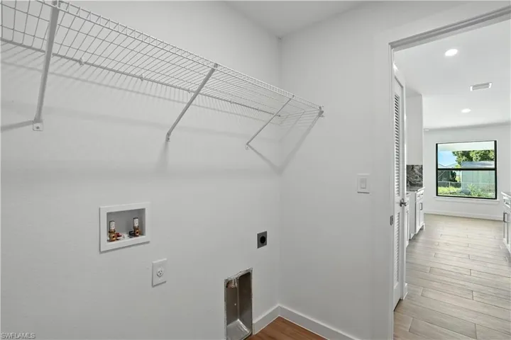 Laundry room featuring electric dryer hookup, light wood-style flooring, recessed lighting, and washer hookup