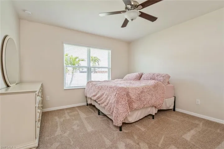 Carpeted bedroom with ceiling fan