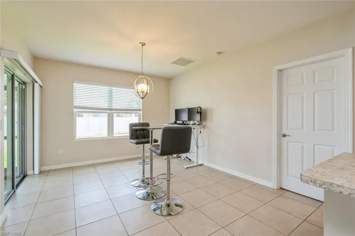 Kitchen featuring hanging light fixtures, an inviting chandelier, and light tile floors
