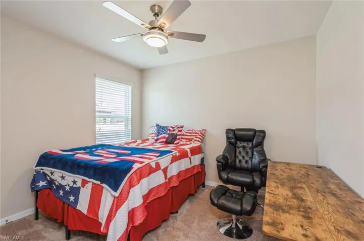 Carpeted bedroom with ceiling fan