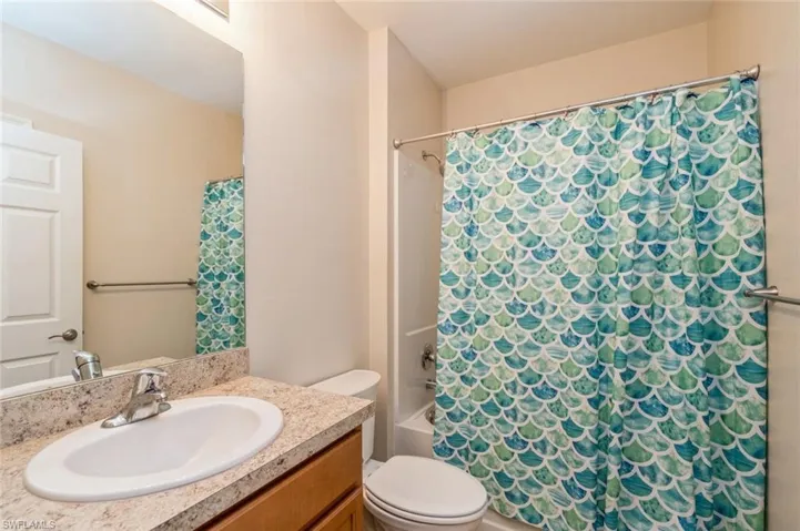 Full bathroom featuring shower / bath combo, toilet, and vanity
