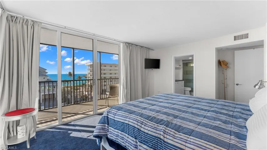 Bedroom with access to exterior, carpet floors, and ensuite bath