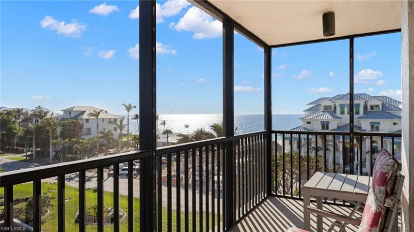 Sunroom / solarium with a water view and plenty of natural light