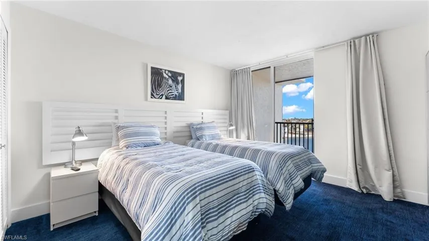 Carpeted bedroom with access to outside