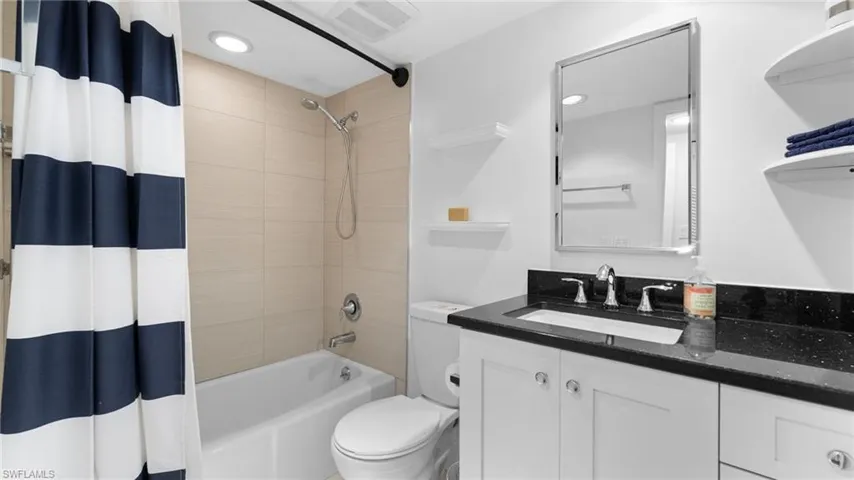 Full bathroom with vanity, toilet, and shower / tub combo