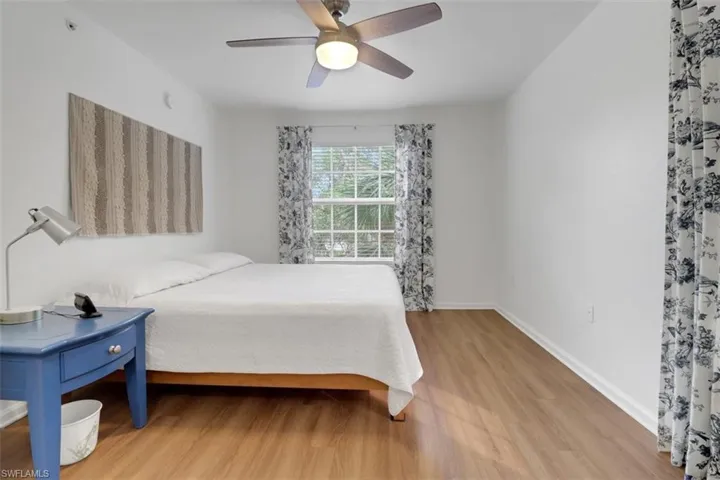 Bedroom with ceiling fan and light wood-type flooring