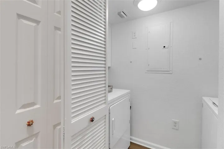 Laundry area with separate washer and dryer and electric panel