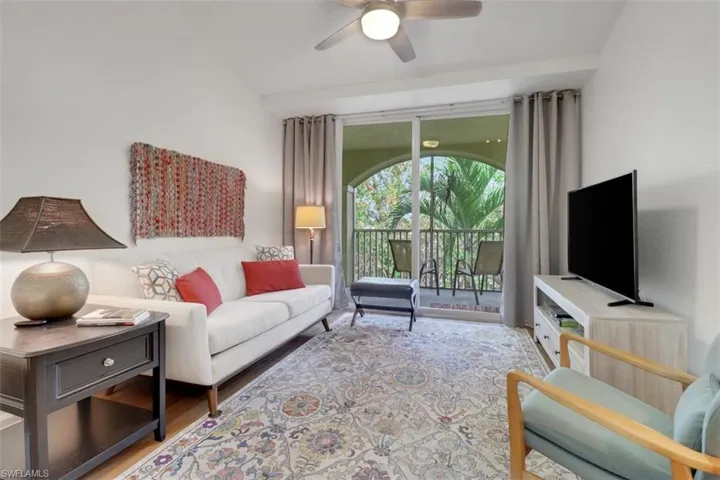 Living room featuring ceiling fan and light wood-type flooring