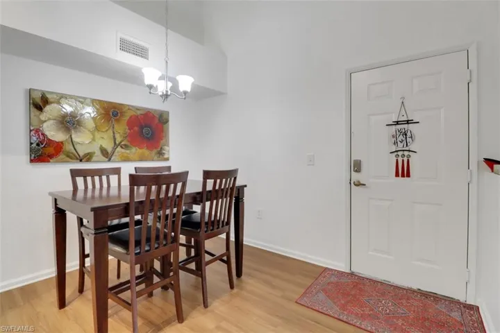 Dining room featuring wood-type flooring and an inviting chandelier