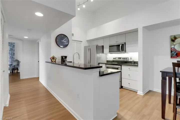 Kitchen featuring stainless steel appliances, light hardwood / wood-style flooring, and kitchen peninsula